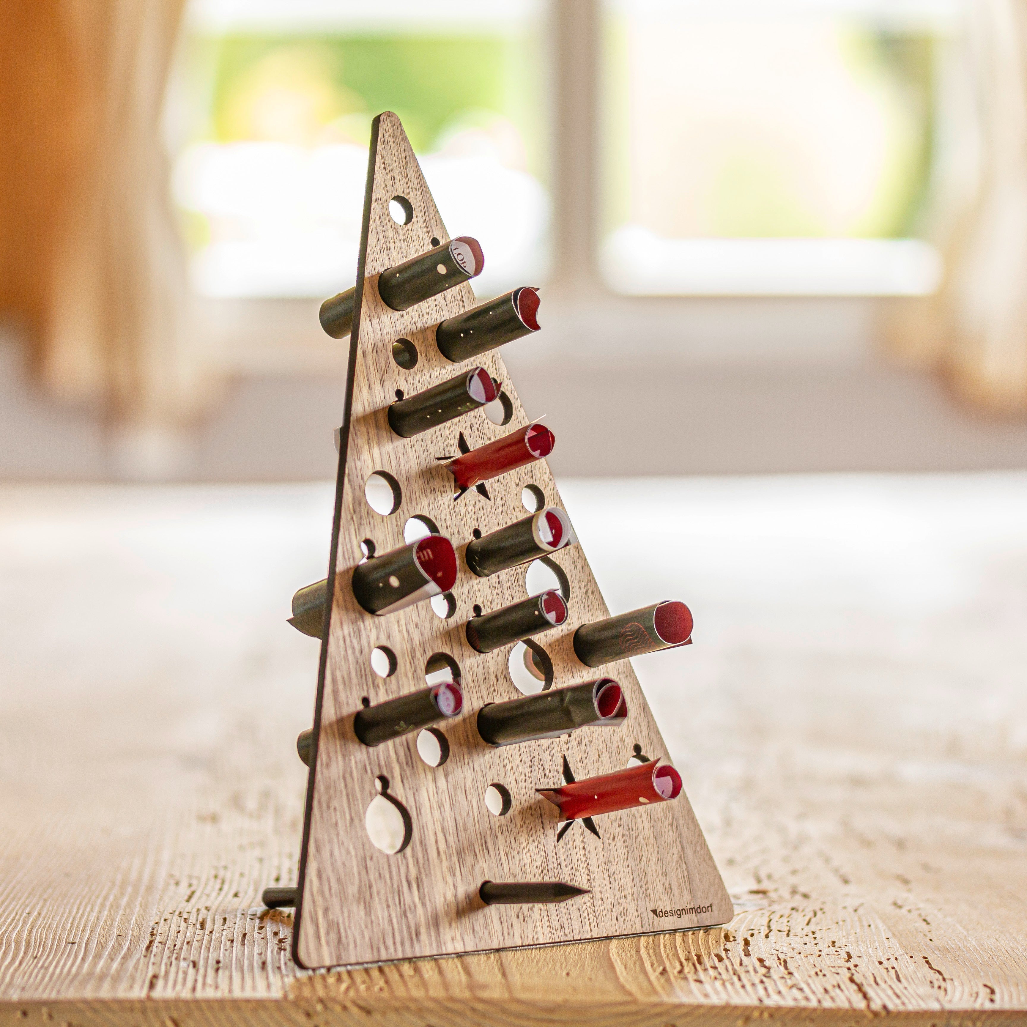 Ein Adventskalender aus Holz und Papier steht auf einem Tisch.