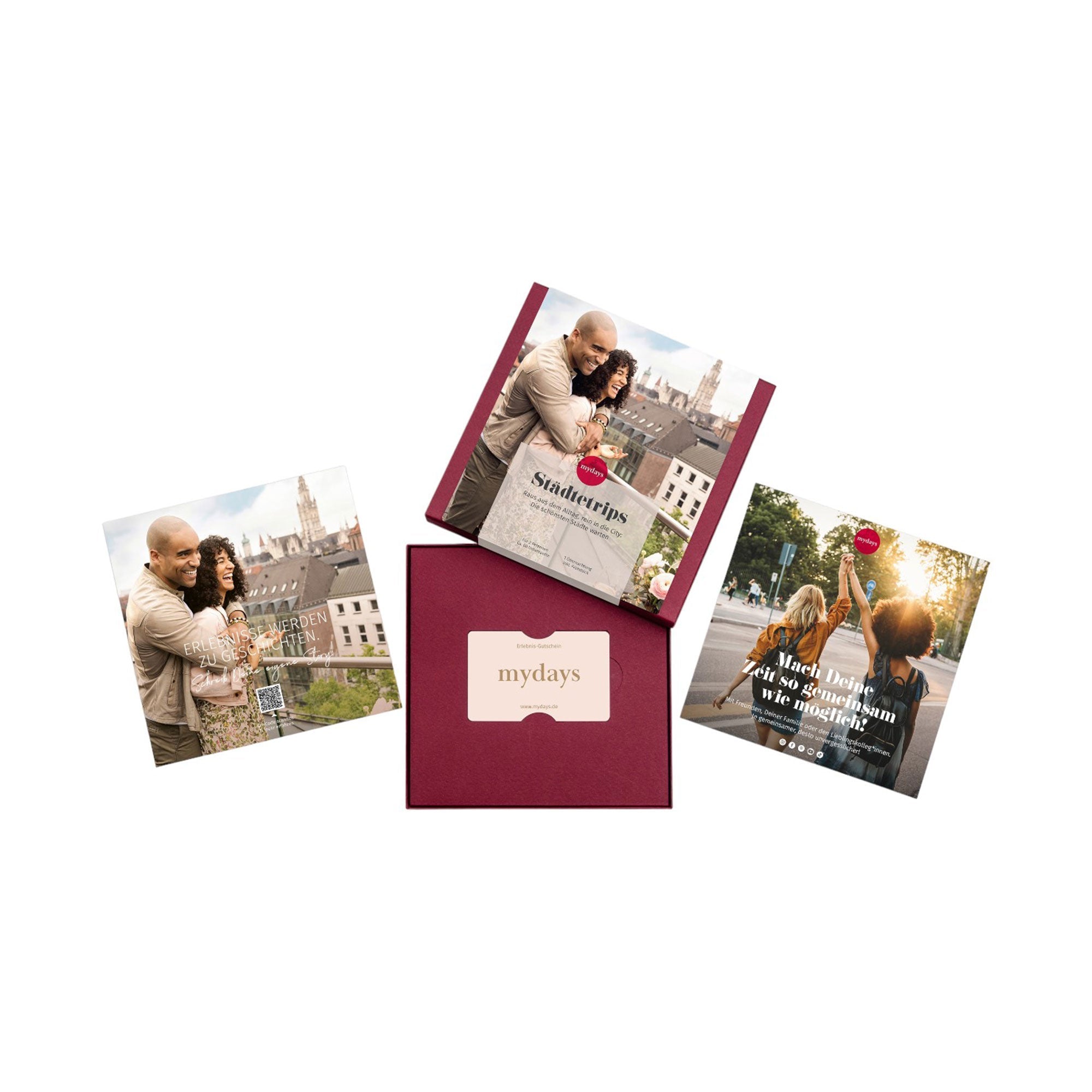 Neben einer roten „mydays“-Box mit der Aufschrift „Erlebnis-Box Städtetrips“ liegen drei Reisebroschüren. Die Broschüren zeigen Paare, die fröhlich Städte erkunden, während die Hauptbroschüre für „Kurzreisen Metropolen Europas“ wirbt.