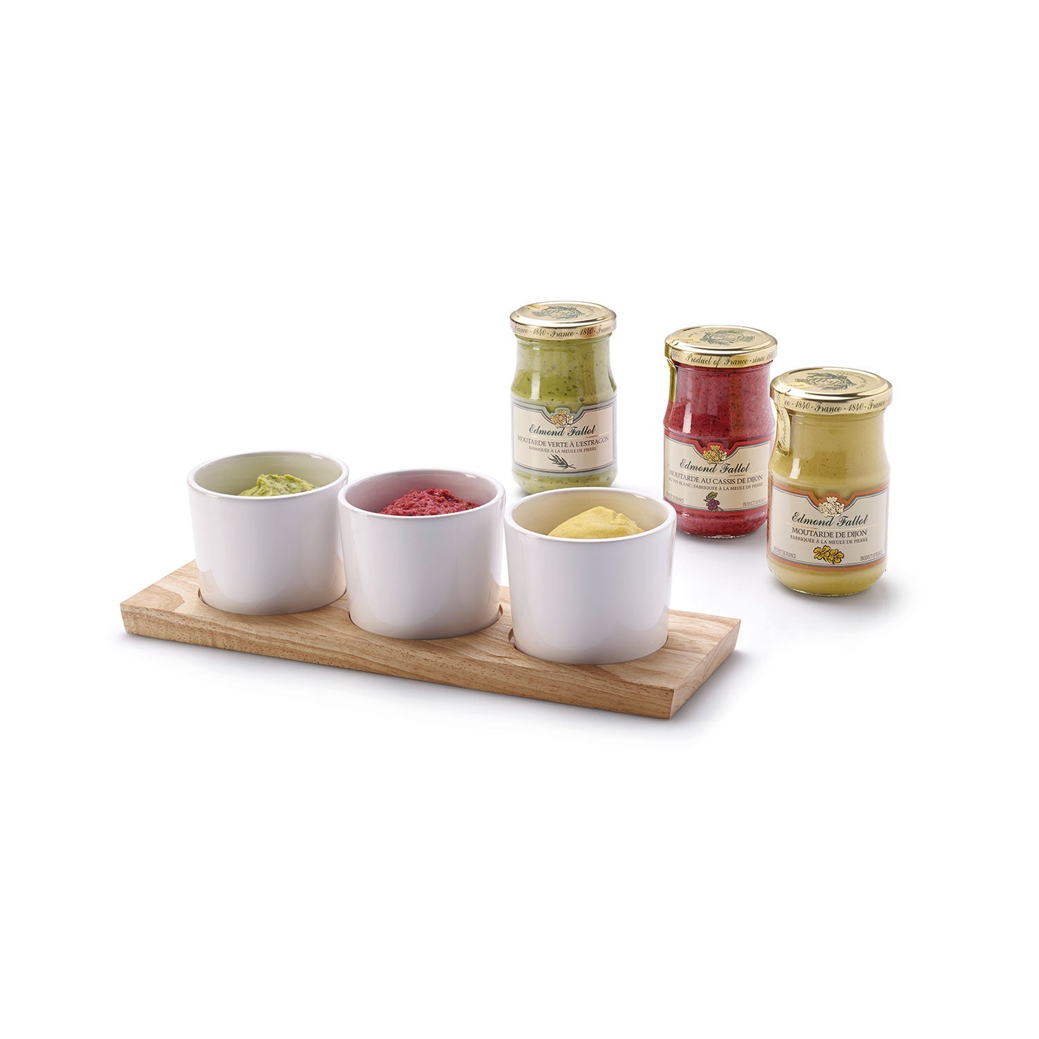 Im Vordergrund befinden sich drei weiße Dipschalen auf einem Tablett aus Gummibaumholz, die verschiedenfarbige Pulver enthalten. Im Hintergrund stehen drei Gläser mit goldenen Deckeln und unterschiedlichen Farben vor einem weißen Hintergrund.