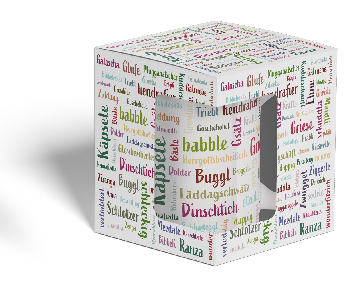 Die Mundart-Tasse ist ein Becher, der mit farbenfrohen deutschen Wörtern, darunter auch regionalen Ausdrücken aus dem Schwabenland, in verschiedenen Schriftarten und Ausrichtungen verziert ist.