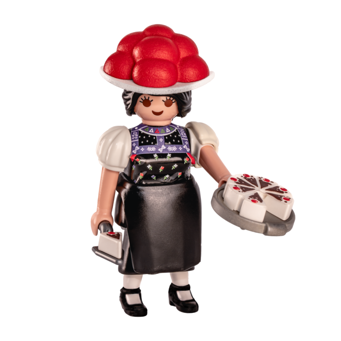 Playmobil Schwarzwald Marie mit Beerenhut, Torte und einem Tortenstück.