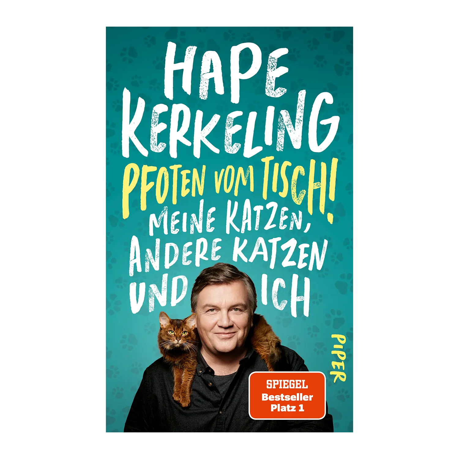 Buchdeckel: Hape Kerkeling lächelt mit einer braunen Katze - Pfoten vom Tisch