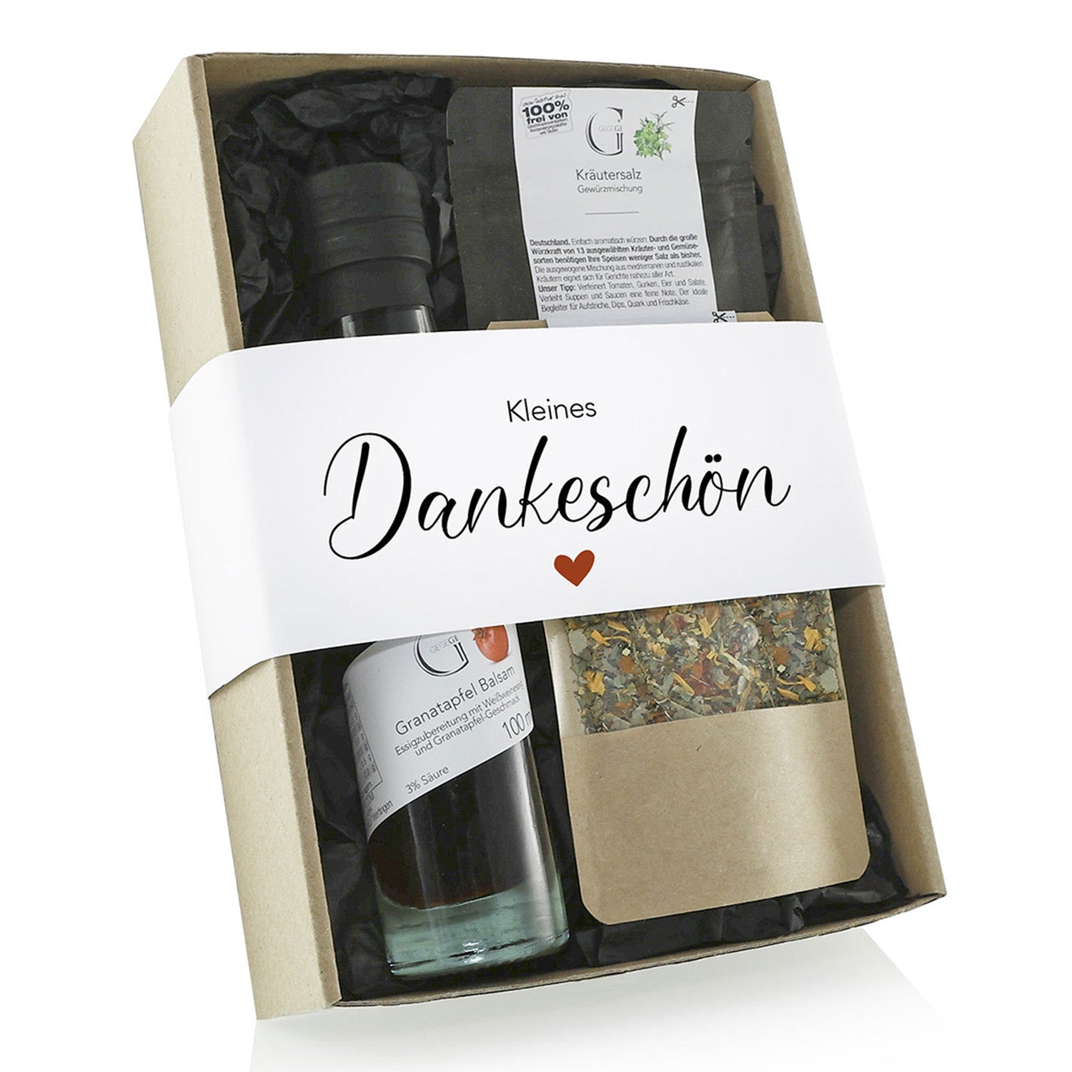 Die Geschenkbox „Kleines Dankeschön Geschenk“ enthält eine Flasche Granatapfel-Balsamico-Essig und eine Kräutersalzmischung, alles eingebettet in schwarzes Papier mit einem roten Herz. Perfekt, um Dankbarkeit mit Stil auszudrücken.